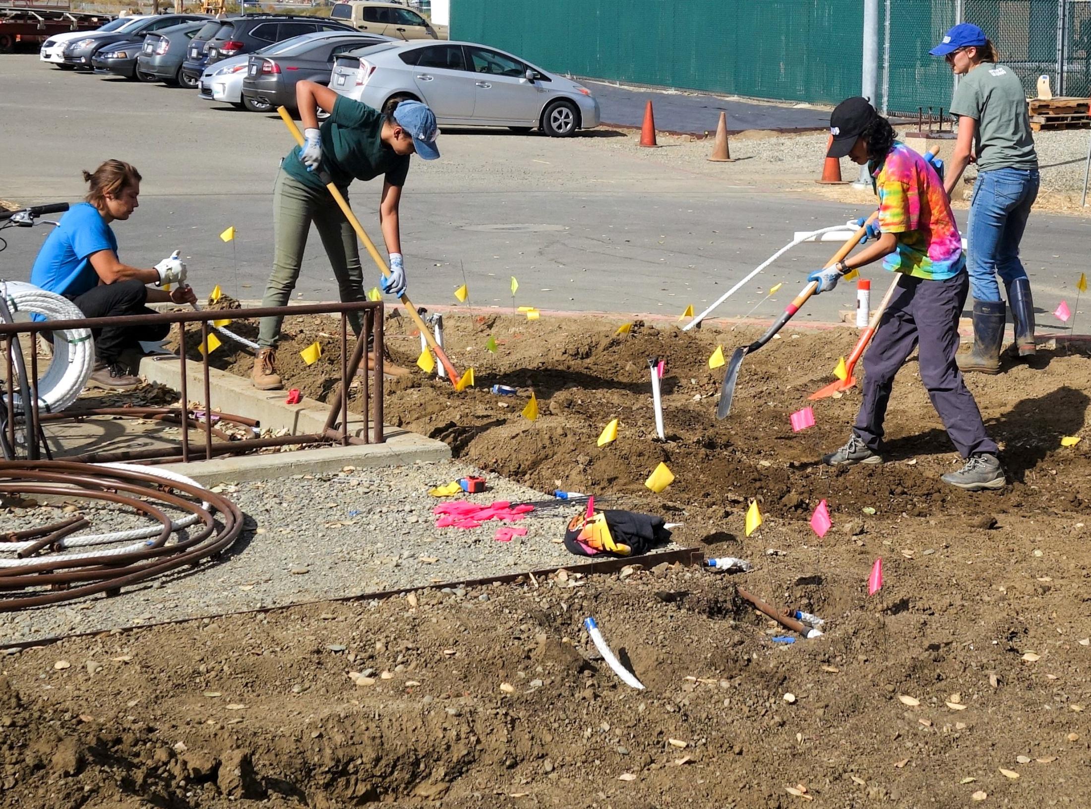 SmartScape team members prepare the bare ground in SmartScape I for irrigation installation.